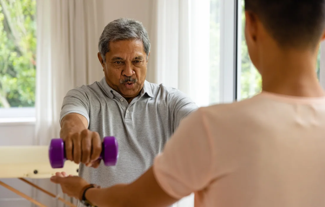 Senior performing guided physical therapy exercises
